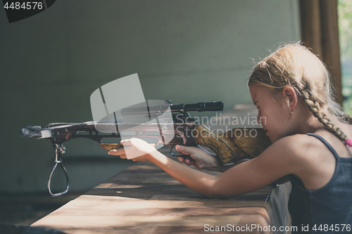 Image of girl shoots a rifle in the dash