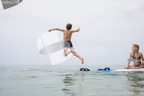 Image of Happy children playing on the beach at the day time.