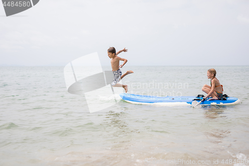 Image of Happy children playing on the beach at the day time.