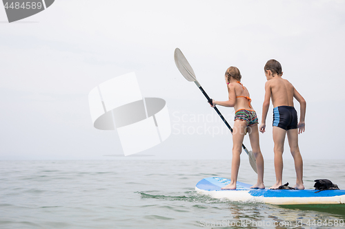 Image of Happy children playing on the beach at the day time.