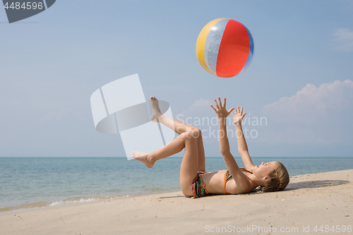 Image of One happy little girl playing on the beach at the day time.