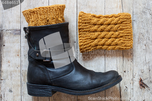 Image of black leather boot and knitted wood legwarmers