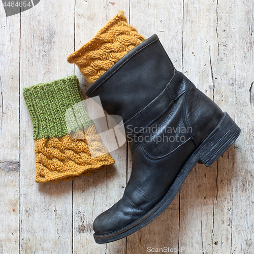 Image of black leather boot and knitted wood legwarmers 