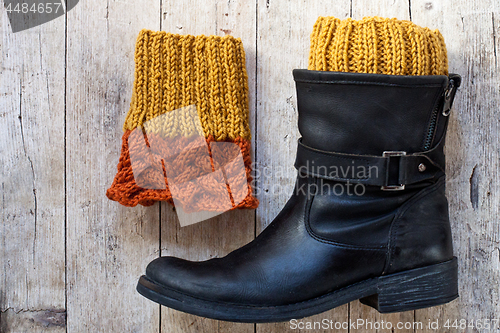 Image of black leather boot and knitted wood legwarmers