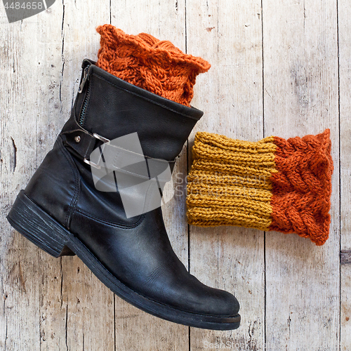 Image of black leather boot and knitted wood legwarmers