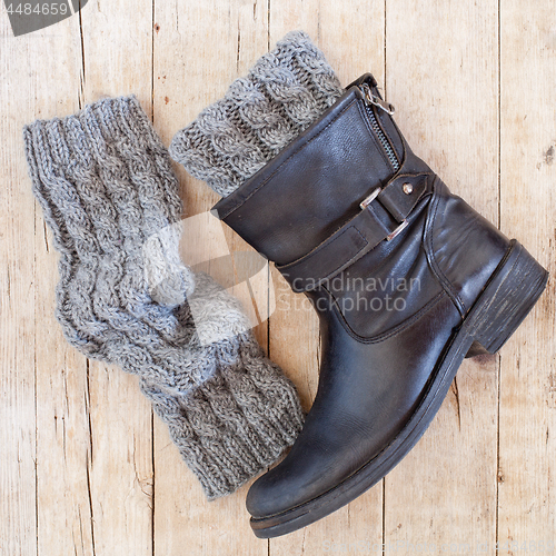 Image of black leather boot and grey knitted wood legwarmers 