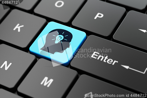 Image of Advertising concept: Head With Light Bulb on computer keyboard background