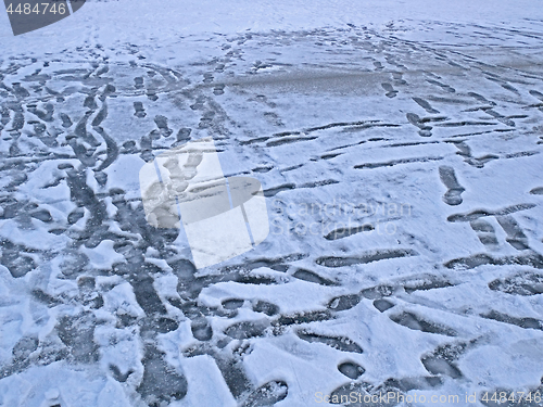 Image of Frozen surface of lake with many prints