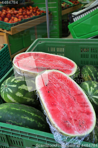 Image of Halves of a large juicy ripe watermelon in the store 