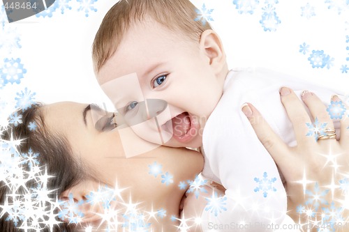 Image of laughing baby playing with mother