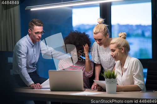 Image of Multiethnic startup business team in night office