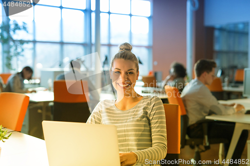 Image of businesswoman using a laptop in startup office