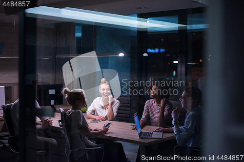 Image of Multiethnic startup business team in night office