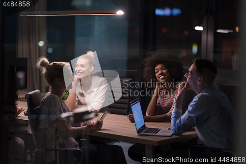 Image of Multiethnic startup business team in night office