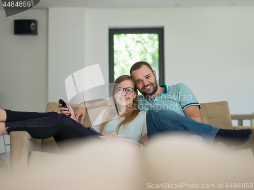 Image of Young couple on the sofa watching television