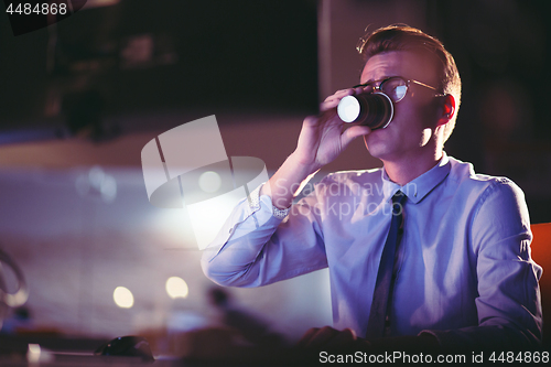 Image of Tired businessman working late