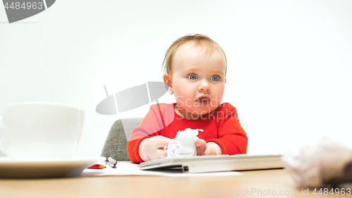 Image of Happy child baby girl toddler sitting with keyboard of computer isolated on a white background