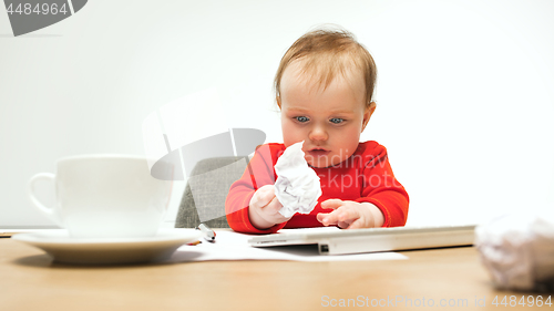 Image of Happy child baby girl toddler sitting with keyboard of computer isolated on a white background