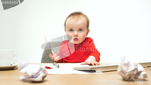 Image of Happy child baby girl toddler sitting with keyboard of computer isolated on a white background
