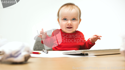 Image of Happy child baby girl toddler sitting with keyboard of computer isolated on a white background