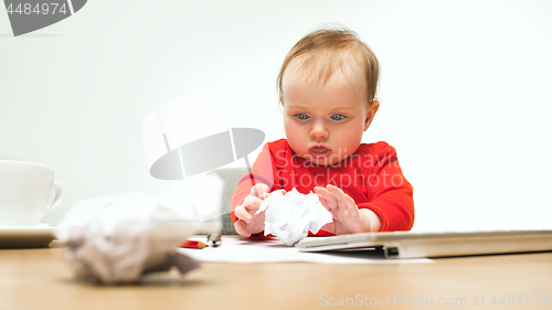 Image of Happy child baby girl toddler sitting with keyboard of computer isolated on a white background