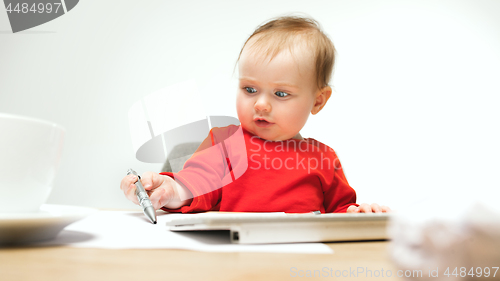 Image of Happy child baby girl toddler sitting with keyboard of computer isolated on a white background