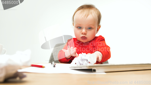 Image of Happy child baby girl toddler sitting with keyboard of computer isolated on a white background