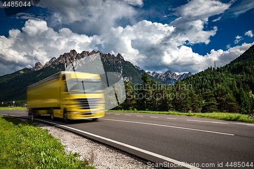 Image of Fuel truck rushes down the highway in the background the Alps. T