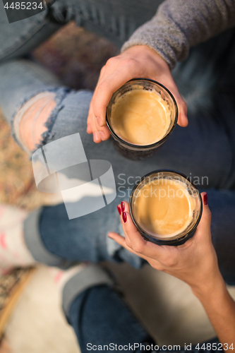 Image of close up of couple with coffee glasses at home