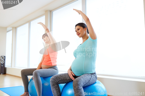 Image of pregnant women training with exercise balls in gym