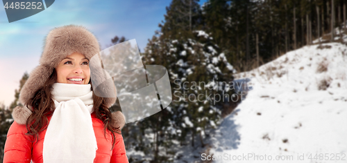 Image of happy woman in winter fur hat outdoors