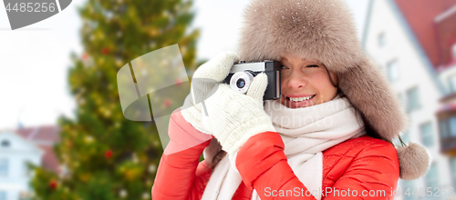 Image of woman with camera over christmas tree in tallinn