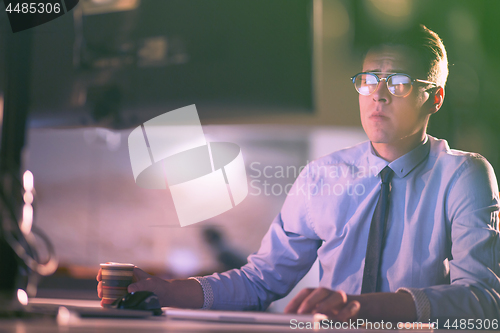 Image of Tired businessman working late