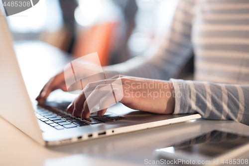 Image of businesswoman using a laptop in startup office