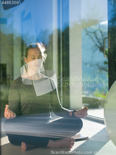 Image of young woman doing morning yoga exercises