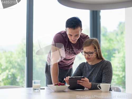 Image of couple enjoying morning coffee and strawberries