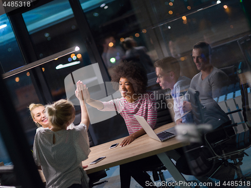 Image of Multiethnic startup business team in night office