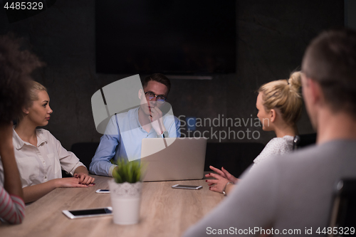 Image of Multiethnic startup business team in night office