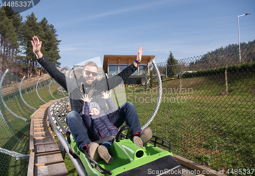 Image of father and son enjoys driving on alpine coaster