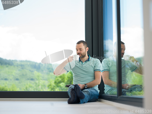 Image of man on the floor enjoying relaxing lifestyle