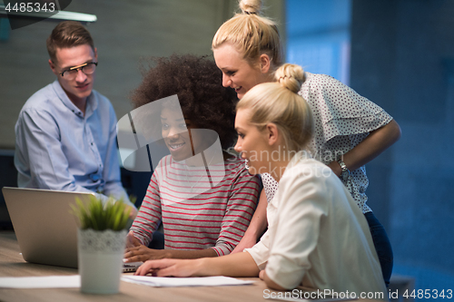 Image of Multiethnic startup business team in night office