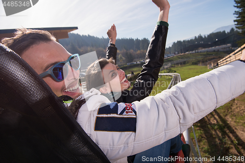 Image of couple enjoys driving on alpine coaster