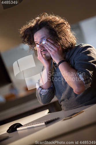 Image of businessman relaxing at the desk