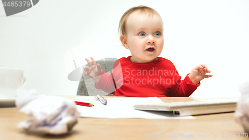 Image of Happy child baby girl toddler sitting with keyboard of computer isolated on a white background