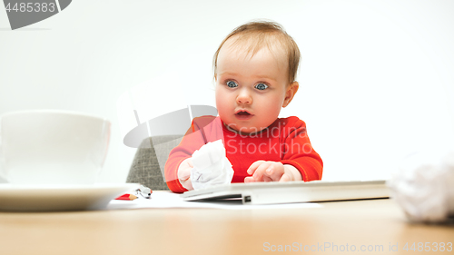 Image of Happy child baby girl toddler sitting with keyboard of computer isolated on a white background