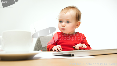 Image of Happy child baby girl toddler sitting with keyboard of computer isolated on a white background