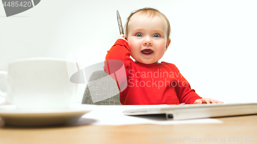 Image of Happy child baby girl toddler sitting with keyboard of computer isolated on a white background