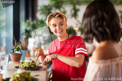 Image of female friends eating at restaurant