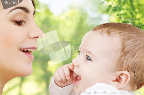 Image of mother with baby over green natural background