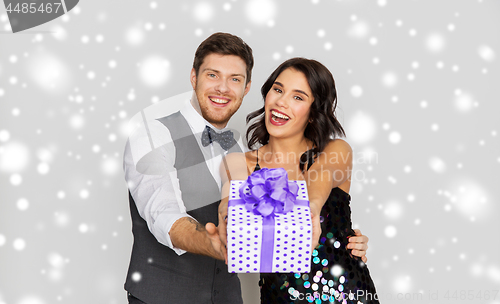 Image of happy couple with christmas gift